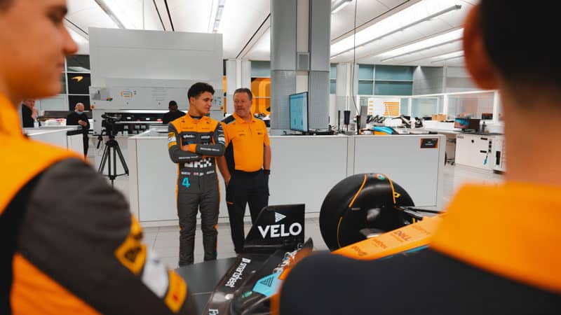 Lando Norris talks with McLaren boss Zak Brown