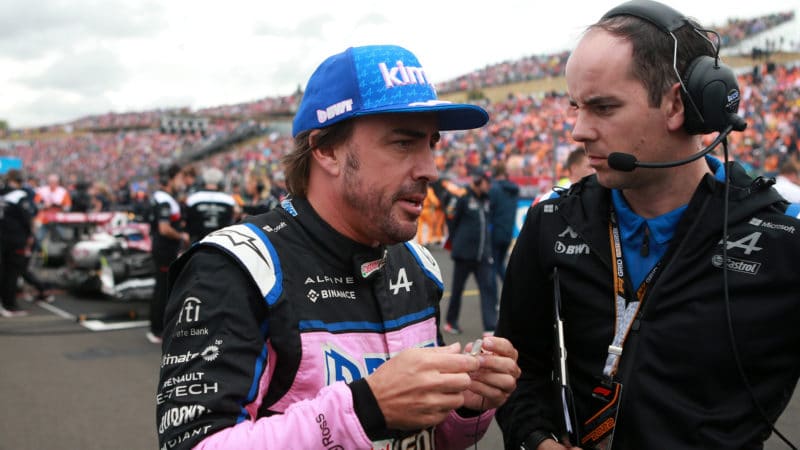 Fernando-Alonso-talks-to-Alpine-engineer-on-the-grid-at-2022-Hungarian-Grand-Prix
