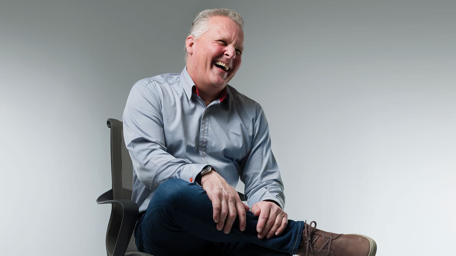 Johnny Herbert sitting and laughing