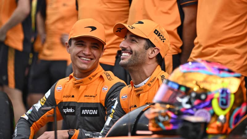 Lando Norris and Daniel Ricciardo smile in 2022 McLaren F1 team photo