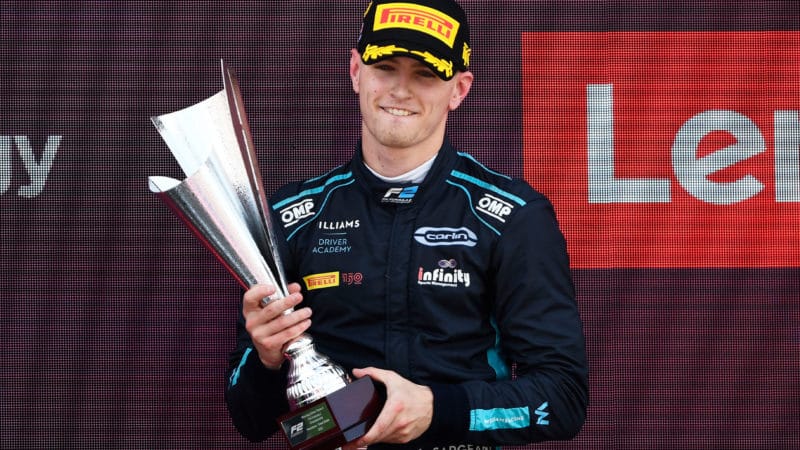 Logan Sargeant holds trophy after winning 2022 F2 race at Silverstone