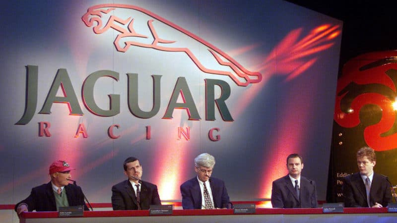 Niki Lauda Guenther Steiner and Steve Nichols sit at table during 2002 Jaguar F1 car launch