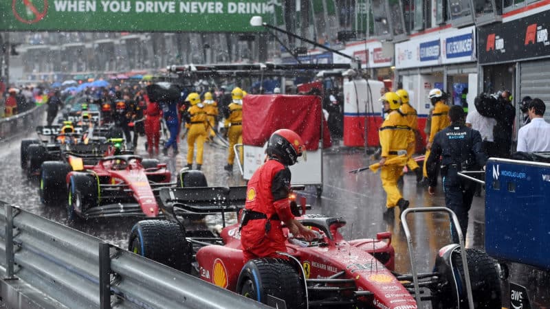 Rain falls on F1 cars in the pit lane at the 2022 Monaco Grand Prix