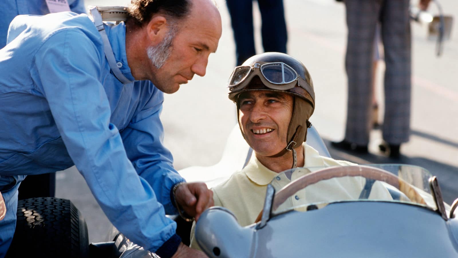 Stirling Moss leans into the Mercedes of Juan Manuel Fangio at 1976 Long Beach Historic race