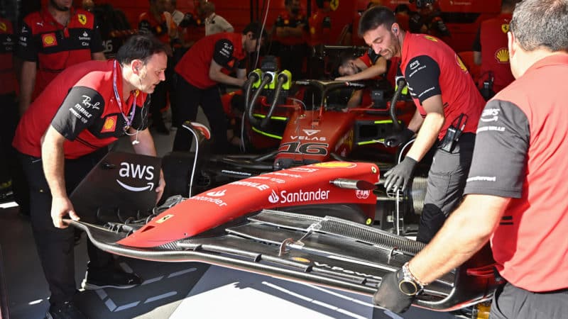 Ferrari mechanics fit front wing to Charles Leclerc F1 car