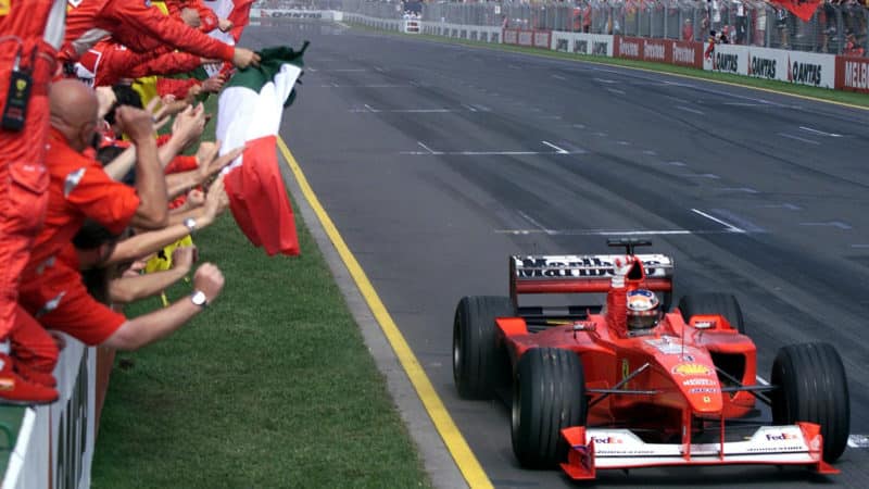 Ferrari team on pitwall cheer as Michael Schuamkcher crosses the line to win 2000 Australian Grand prix