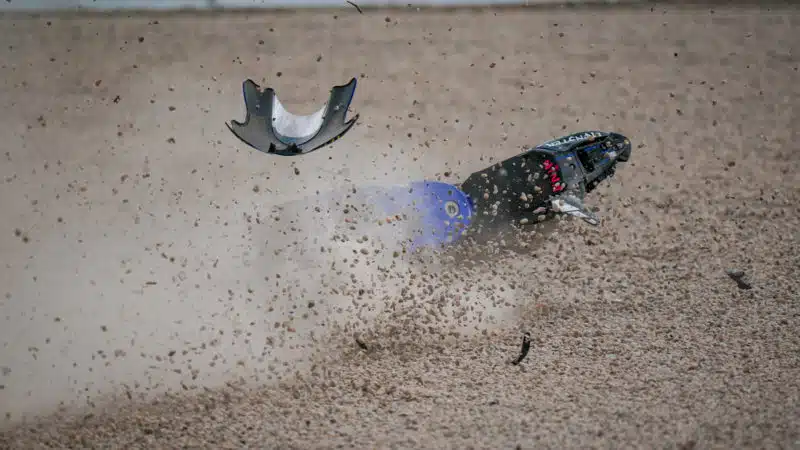Gravel flies around crashed Yamaha of Maverick Vinales