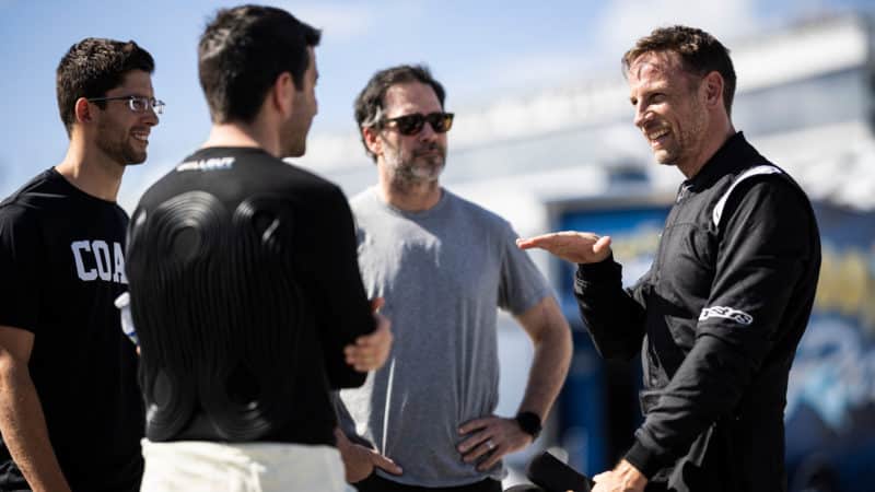 Jenson Button talking with Jimmie Johnson Mike Rockenfeller and Jordan Taylor