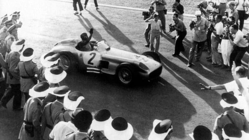 Juan Manuel Fangio and Mercedes surrounded bhy crowd after winning 1955 Argentine Grand Prix