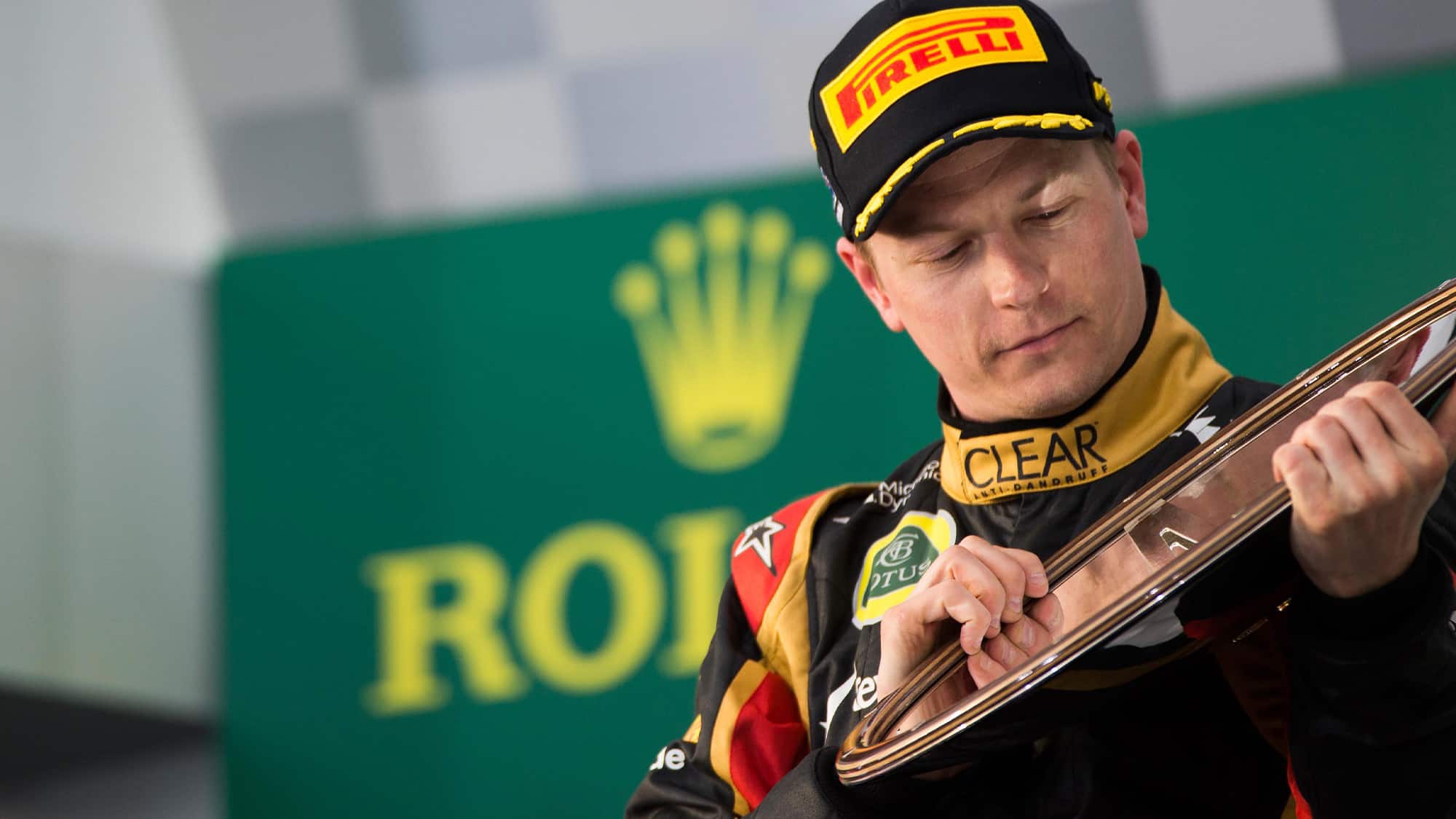 Kimi Raikkonen holds 2013 australian Grand prix winning trophy