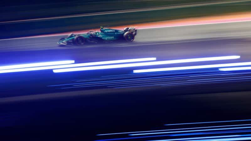 Lights blurred as Aston Martin races at night in 2023 F1 Saudi Arabian Grand Prix