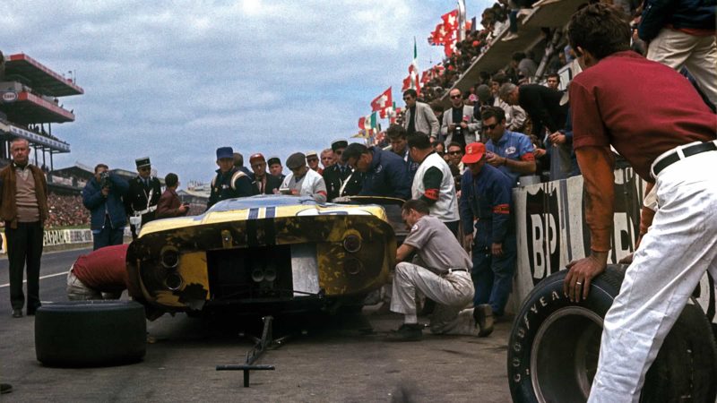 Mechanics work on car race car