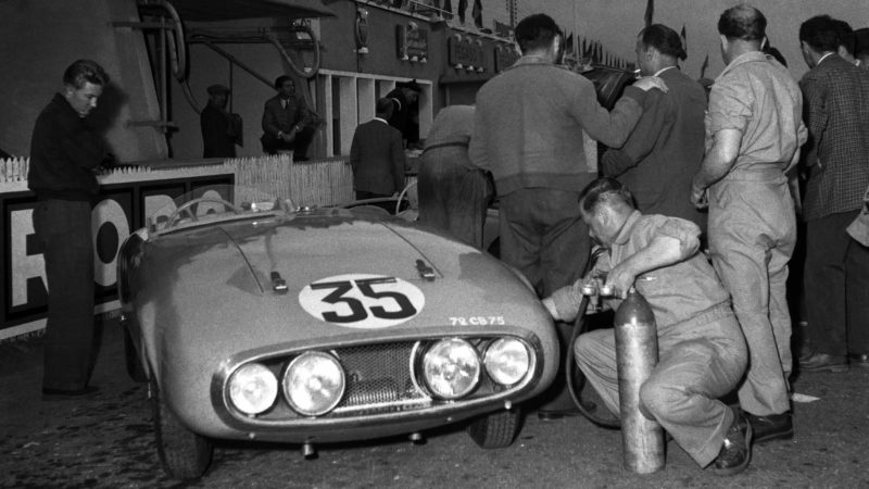 Men preparing car for race