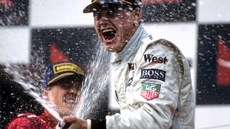 Michael Schumacher sprays David Coulthard with champagne on the podium at 1997 Australian GP