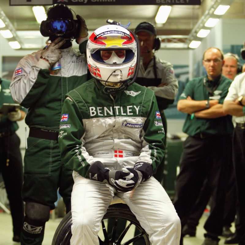 Tom Kristensen sitting on wheel at Le Mans 2003