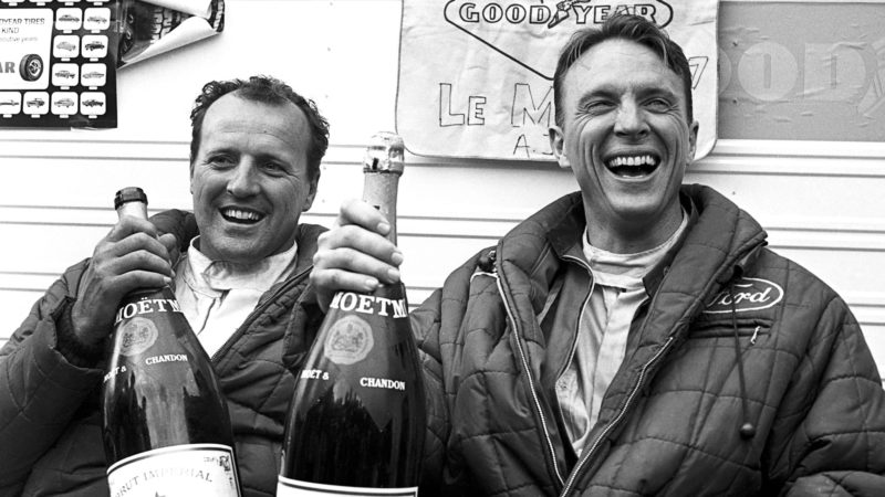 AJ Foyt and Dan Gurney drink champagne