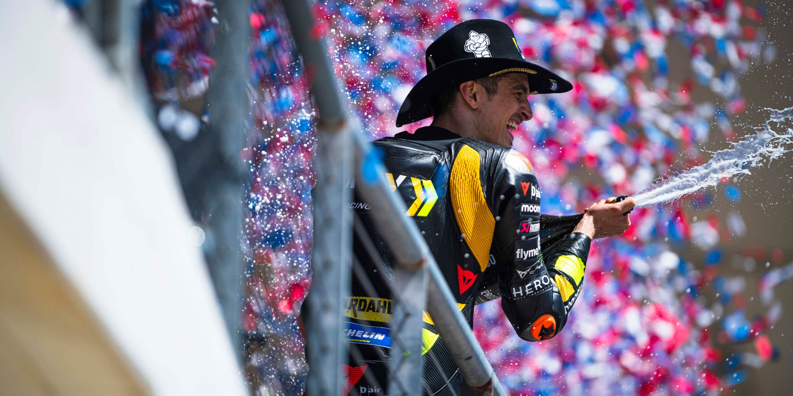 Luca-Marini-sprays-champagne-on-the-podium-at-COTA