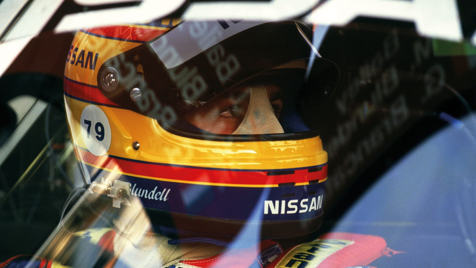 Close up of Martin Brundle behind the wheel