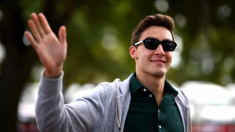 George Russell waves to the crowd as he arrives at the 2023 Australian GP paddock