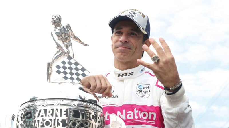 Hélio Castroneves holds up 4 fingers