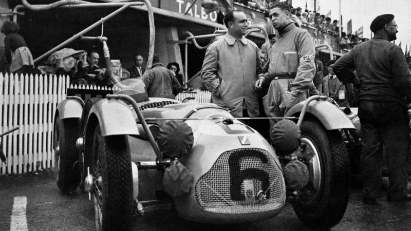 Louis Rosier and Juan Manuel Fangio pose near their Talbot Lago