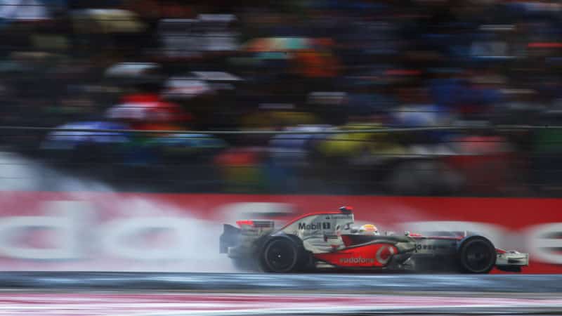 McLaren of Lewis Hamilton produces a rooster tail of spray at the 2008 British Grand Prix