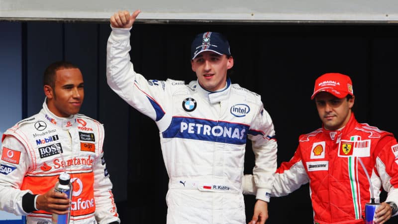 Robert Kubica stands between Lewis Hamilton and Felipe Massa at the 2008 Bahrain Grand Prix