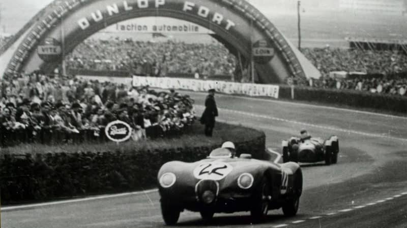 Jaguar C type of Stirling Moss with Dunlop Bridge in background at Le Mans 24 Hours 1951