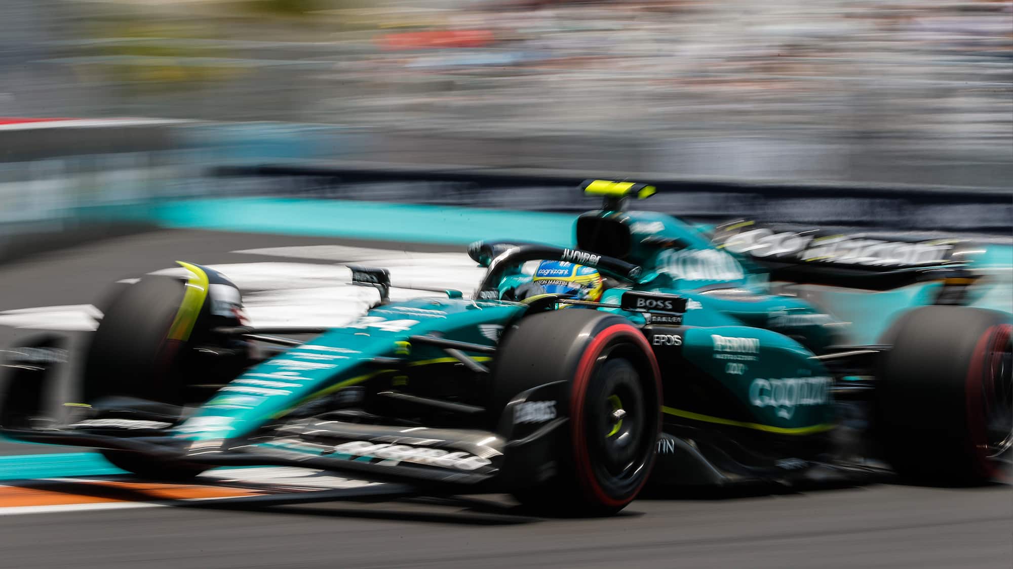 Blurred image of Fernando Alonso in Aston Martin at 2023 Miami GP