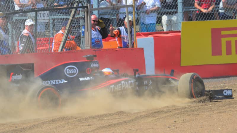 Feranando Alonso spins into gravel in McLaren Honda during 2015 F1 British Grand Prix
