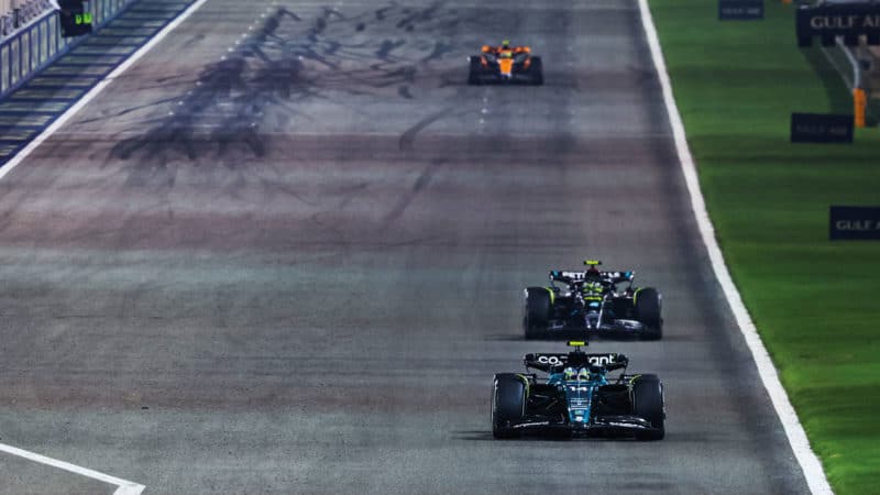 Fernando Alonso leads Lewis Hamilton in his Aston Martin