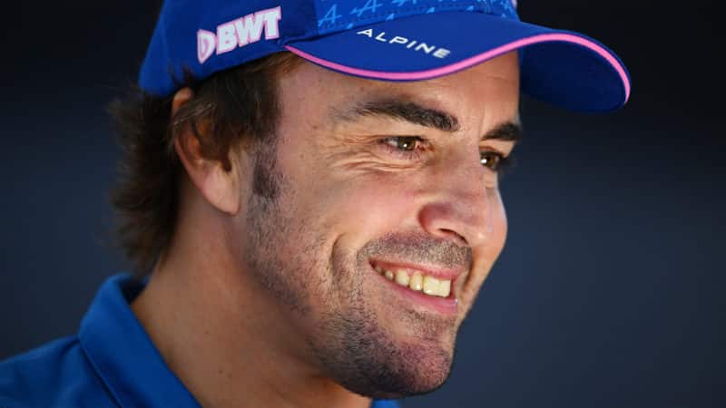 Fernando Alonso smiles wearing an Alpine cap in 2022