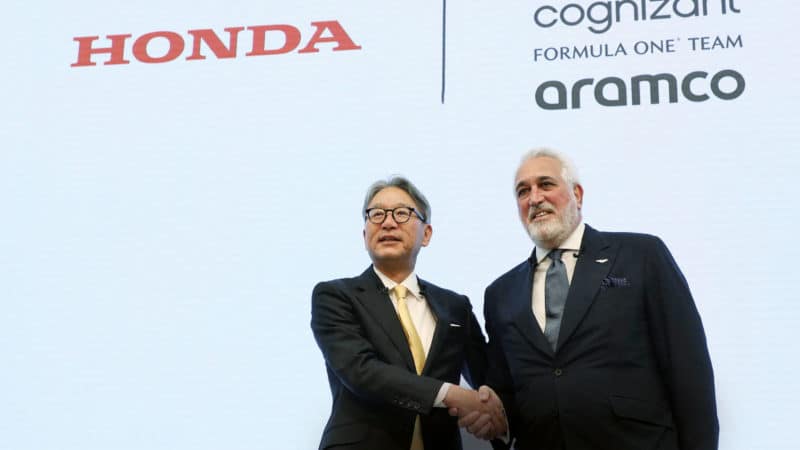 Honda CEO Toshiro Mibe and Lawrence Stroll shake hands