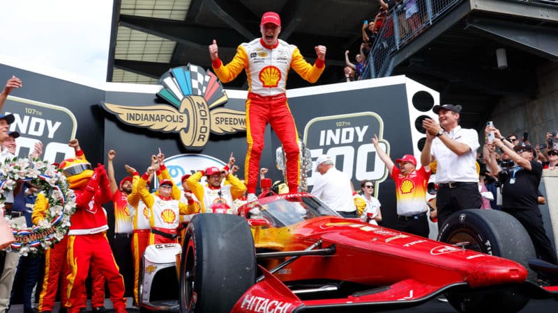Josef Newgarden celebrates on his car in Victory Lane after winning 2023 Indy 500