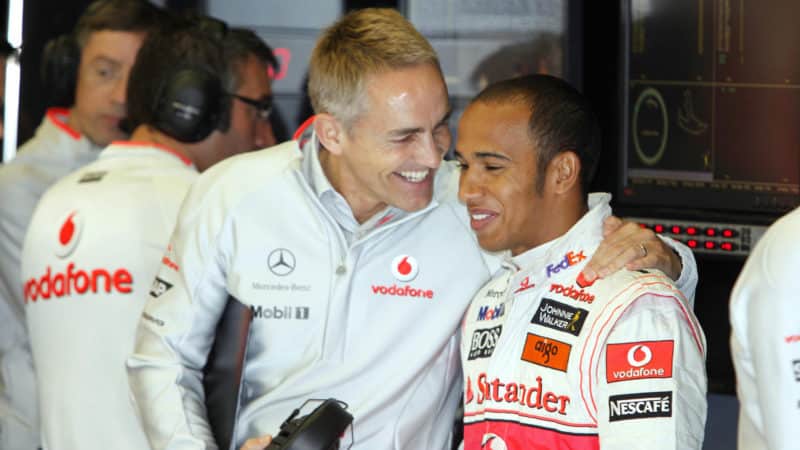 Martin Whitmarsh puts arm around Lewis Hamilton in McLaren pit garage in 2009