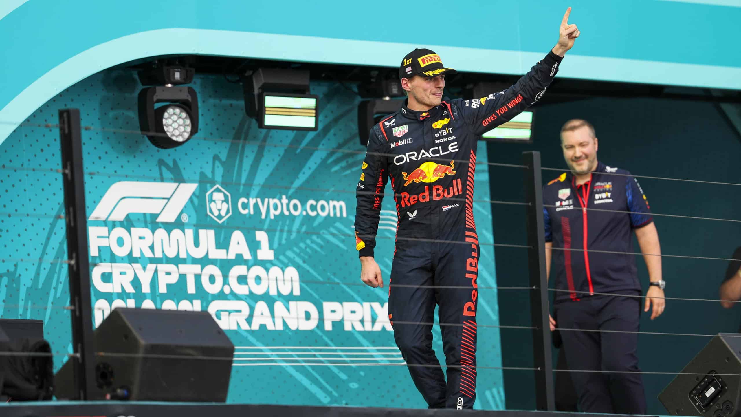 Max-Verstappen-raises-finger-on-podium-after-winning-2023-F1-Miami-GP