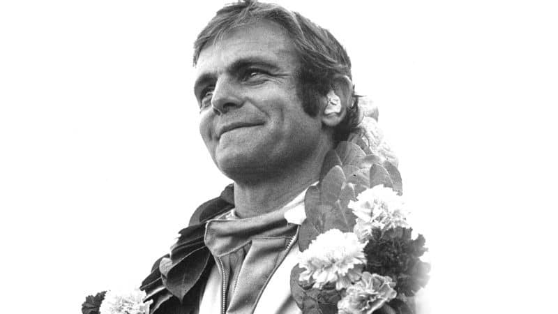 Peter Revson smiles on podium