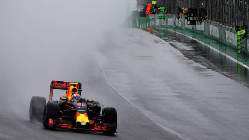 Red Bull of Max Verstappen in front of cloud of spray at we 2016 Brazilian Grand Prix