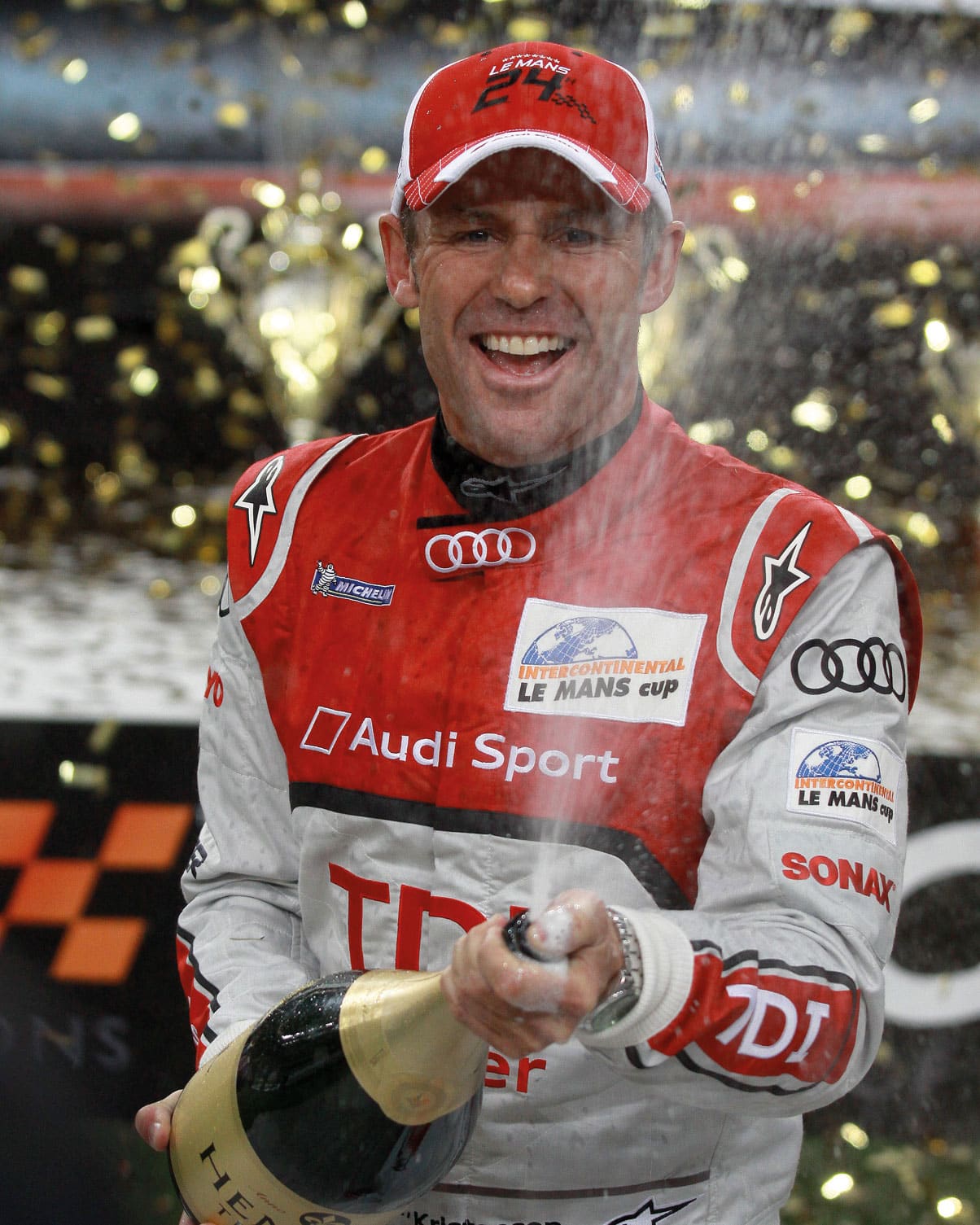 Tom Kristensen spraying champagne