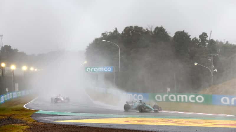 Aston Martin of Lance Stroll in spray and rain at 2022 Japanese Grand Prix