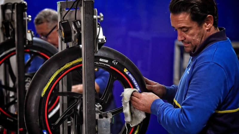 Engineer works on Michelin tyre in MotoGP paddock
