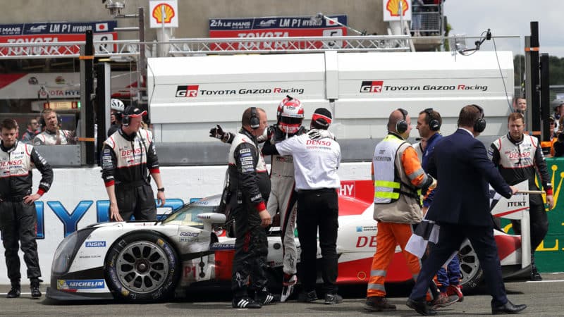 Kazuki Nakajima is supported as he gets out of stranded Toyota at 2016 Le Mans 24 Hours