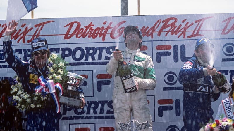 Michele Alboreto on 1983 Detroit GP podium with Keke Rosberg
