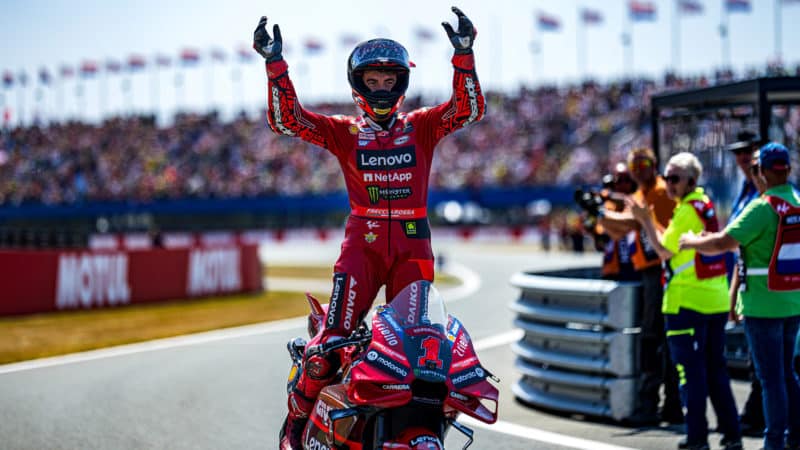 Pecco Bagnaia raises arms on Ducati after winning MotoGP 2023 Assen TT