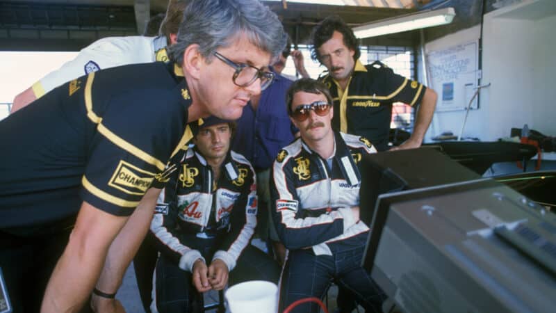 Peter Warr looks at monitor with Nigel Mansell and Elio de Angelis