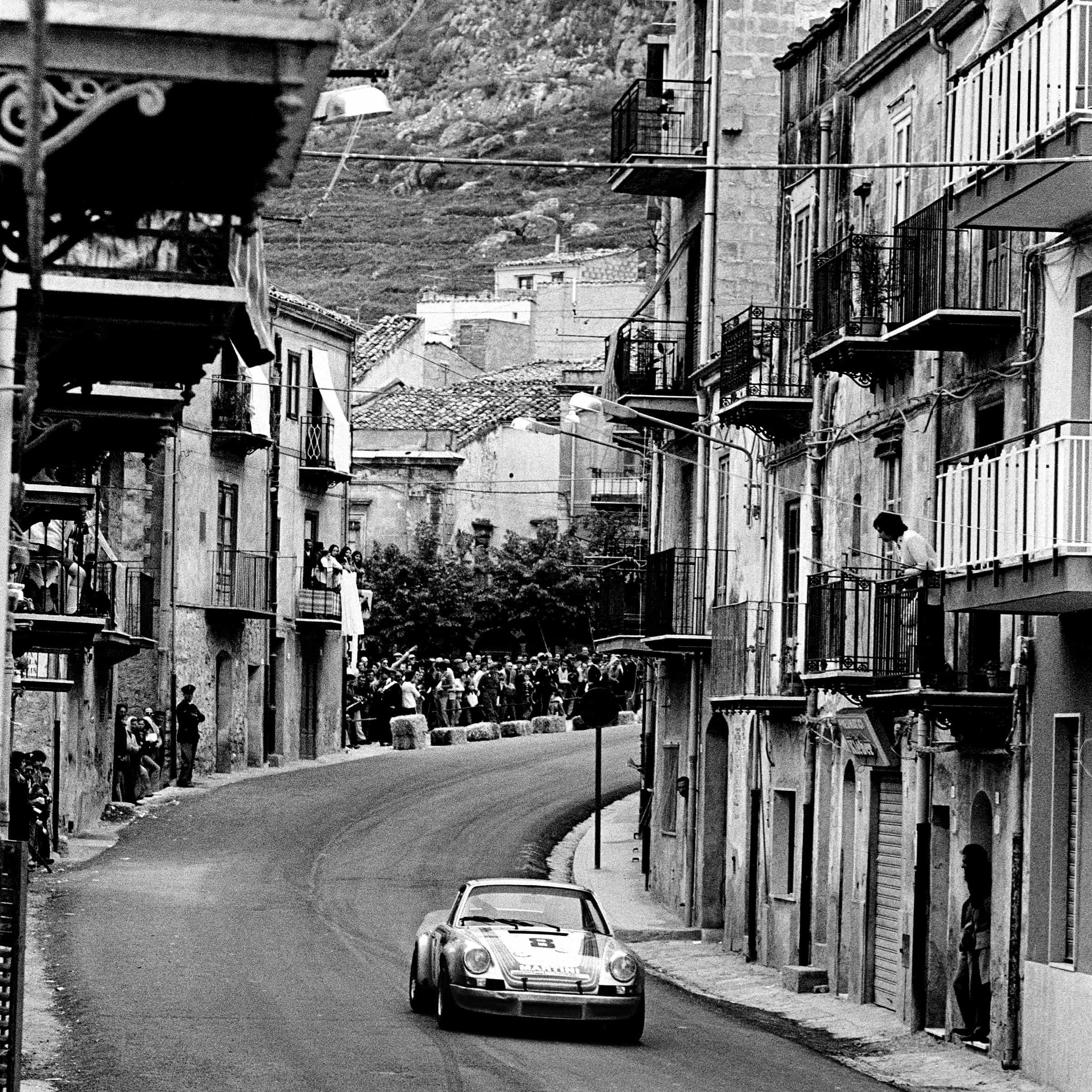 Porsche 911 RSR drives through town