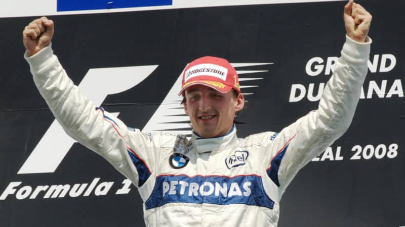 Robert Kubica with arms in the air celebrates on the podium after winning 2008 Canadian Grand Prix