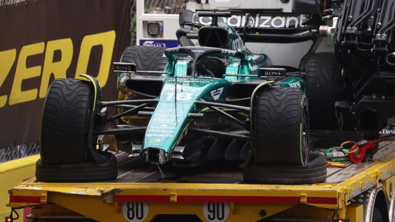 Wrecked Aston Martin is taken away on flatbed truck at 2023 Monaco Grand Prix