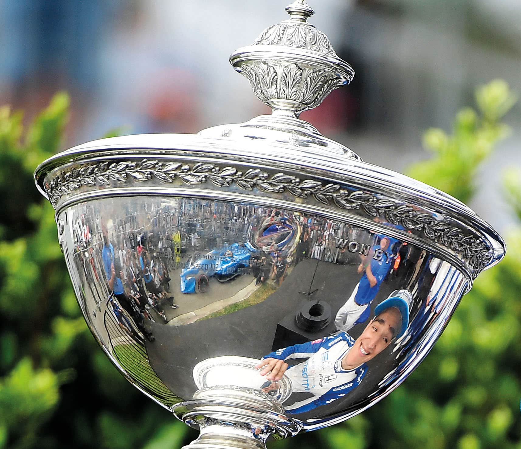 Alex Palou reflected in his championship IndyCar trophy in 2021