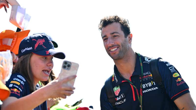 Daniel Ricciardo takes pictures with fans at the 2023 British Grand Prix